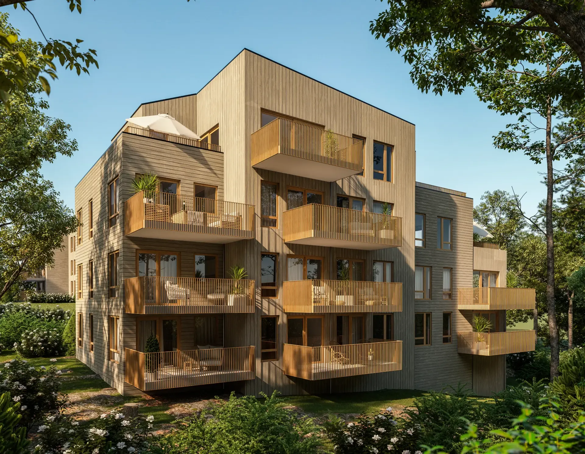 Et visualiseringsbilde av et boligprosjekt. Bygget går over flere etasjer, har trekledning og ligger i frodige omgivelser.